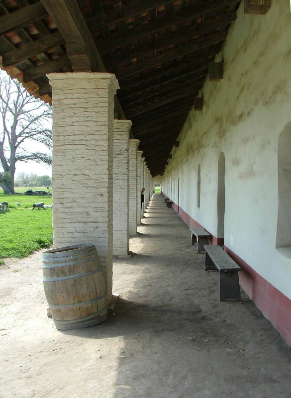 Mum peaking out from behind some columns at La Purisima Mission, Lompoc, California