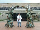 Jo outside the George C Page museum under the arch of a sculpture made to look like bones retrieved from the pits.