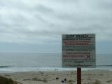 A sign on the beach on the west coast, near Lompoc.