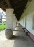 Mum peaking out from behind some columns at La Purisima Mission, Lompoc, California